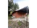 Side view of a boarded up red brick home with an awning at 1827 Thomasville Se Dr, Atlanta, GA 30315