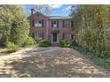 Charming brick home with black shutters, mature landscaping, and a stone pathway to the front entrance at 619 E Pelham Ne Rd, Atlanta, GA 30324