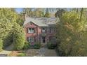 Beautiful brick home with a classic design, surrounded by lush greenery and mature trees at 619 E Pelham Ne Rd, Atlanta, GA 30324