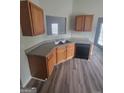 Functional kitchen features wood cabinetry, stainless steel sink, and modern dishwasher at 1354 Persimmon Ct, Lithonia, GA 30058