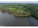 Beautiful aerial view of a lakeside home surrounded by mature trees at 504 Telfair Pk at 504 Telfair Park, Peachtree City, GA 30269