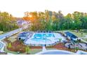 Aerial view of the community pool and playground area with mature trees at 566 Silver Moon Drive # 21, Loganville, GA 30052