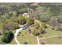 Aerial view of estate featuring landscaped grounds, pool, residence, and outbuildings at 935 Amelia Rd, Locust Grove, GA 30248