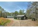 Large garages on property with multiple bays and gravel driveway at 935 Amelia Rd, Locust Grove, GA 30248