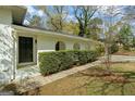 Welcoming front entrance with a covered porch, arched openings, and a well-maintained hedge for added privacy at 1146 Redan Way, Stone Mountain, GA 30088