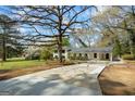 Charming exterior showcasing a well-manicured lawn, covered parking, and tasteful landscaping, enhancing its appeal at 1146 Redan Way, Stone Mountain, GA 30088