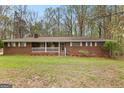 Charming brick ranch-style home with a covered porch and manicured lawn at 1407 Highway 92 N, Fayetteville, GA 30214