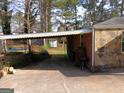 Carport area with ample space, featuring stone and brick accents at 3249 E Stratton Ln, Scottdale, GA 30079
