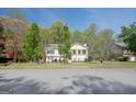 Inviting split-level home with a manicured lawn, mature trees, and a peaceful residential street view at 319 Honeysuckle Ter, Auburn, GA 30011