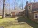 Spacious backyard featuring a deck area connecting to the stone and brick sections of the home's exterior at 3314 Henson Ln, Stockbridge, GA 30281