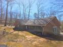 Brick home exterior featuring large windows and a partially covered space at 3314 Henson Ln, Stockbridge, GA 30281