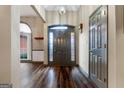 Inviting foyer with hardwood floors, arched window, and a neutral color palette, creating a warm welcome at 205 Wynnfield Way, Mcdonough, GA 30252