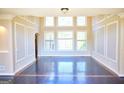 Bright living room featuring large windows and hardwood floors at 65 Lotus Ln, Covington, GA 30016