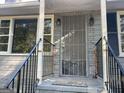 The front porch features a secure front door, railing, and is freshly painted at 5147 Highpoint Rd, Union City, GA 30291