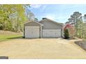 Three car garage with carriage doors offer ample parking and storage space with attractive, neutral exterior at 100 Smokerise Trce, Peachtree City, GA 30269
