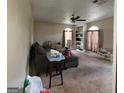 Inviting living room featuring neutral carpet, built-in shelves and a large arched window at 2884 Haddon Dr, Rex, GA 30273