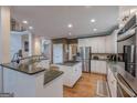 Modern kitchen featuring stainless steel appliances, granite countertops, and hardwood floors at 7415 Northampton Ct, Cumming, GA 30040