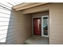 Welcoming entryway featuring a red front door, a sidelight window, and neutral siding at 154 Waverly Way, Alpharetta, GA 30009
