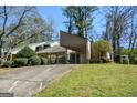 This lovely home features a covered carport and is surrounded by lush greenery and mature trees at 154 Waverly Way, Alpharetta, GA 30009