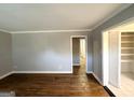 Spacious living room featuring hardwood floors, neutral paint, and ample natural light through the closet at 3729 Glenwood Rd, Decatur, GA 30032
