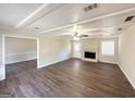 Spacious living room boasts a ceiling fan, fireplace, and new vinyl flooring at 4992 Needle Knob Ct, Lithonia, GA 30038