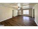 Bright living room featuring modern vinyl flooring, fan, and ample natural light at 4992 Needle Knob Ct, Lithonia, GA 30038