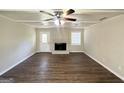 Living room features a ceiling fan, fireplace, and new vinyl flooring at 4992 Needle Knob Ct, Lithonia, GA 30038