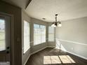 Bright dining area features wood-look flooring and a stylish chandelier at 210 Huntington Dr, Mcdonough, GA 30253