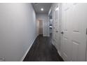 A long hallway with dark wood floors and white walls at 1735 Labonte Pkwy, Mcdonough, GA 30253