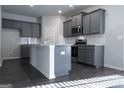 Modern kitchen features gray cabinets, stainless steel appliances, and granite countertops at 1735 Labonte Pkwy, Mcdonough, GA 30253