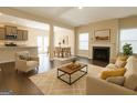 Open-concept living room with fireplace, dining area, and modern furnishings at 1735 Labonte Pkwy, Mcdonough, GA 30253