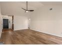 Bright living room with wood-look floors, a ceiling fan, and a view into the entryway at 9591 Teal Ter, Jonesboro, GA 30238