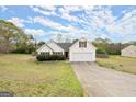 Inviting single-Gathering home with attached two-car garage and manicured lawn and classic design at 1416 Flanagan Mill Dr, Auburn, GA 30011