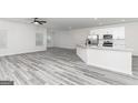 Open-concept living room and kitchen features hardwood floors and lots of natural light at 3363 Arabian Farm Ln, Dacula, GA 30019