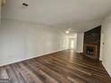 Bright living room with hardwood floors, a ceiling fan, and a stone fireplace at 240 Carsons Cv, Mcdonough, GA 30253
