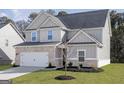 Charming two-story home with a brick and siding facade, attached garage, and well-manicured lawn at 3413 Arabian Farm Ln, Dacula, GA 30019