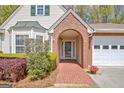 Close-up of the home's entrance, featuring a brick archway and well-kept landscaping at 1010 Pinehurst Dr, Peachtree City, GA 30269
