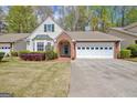 Inviting home with a brick-accented entryway and well-maintained lawn at 1010 Pinehurst Dr, Peachtree City, GA 30269