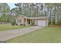 Lovely single-story home with a well-kept lawn, driveway, and attached garage at 212 Bella Rosa, Peachtree City, GA 30269