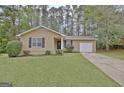 Charming single-story home featuring a well-manicured lawn and cozy curb appeal at 212 Bella Rosa, Peachtree City, GA 30269