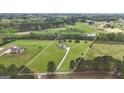 Aerial view of a beautiful home with 7 acres of land and a long driveway at 176 Butler Rd, Brooks, GA 30205