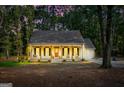 Inviting home exterior with warm lighting, a cozy front porch, and a beautiful evening sky at 105 Honey Creek Rd, Mcdonough, GA 30252