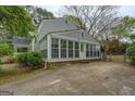 Rear view of the home featuring a sunroom addition and fenced-in yard at 6140 Ginn Se St, Covington, GA 30014