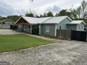 Inviting home with a metal roof, wood beam porch, and sprawling gravel driveway at 6121 N Main Se St, Acworth, GA 30101