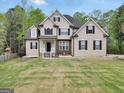 Charming two-story home featuring stone accents, black shutters, and a well-manicured lawn at 70 Barrington Farms Ct, Sharpsburg, GA 30277