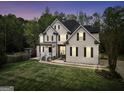 Lovely home at twilight, showcasing its inviting facade, well-maintained lawn, and serene surroundings at 70 Barrington Farms Ct, Sharpsburg, GA 30277