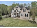 Charming home with manicured lawn, stone accents, and mature trees offers curb appeal and tranquility at 70 Barrington Farms Ct, Sharpsburg, GA 30277