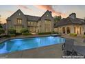 Gorgeous backyard featuring a sparkling pool, spa, and a covered outdoor living space at 140 Newhaven Dr, Fayetteville, GA 30215