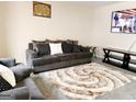 Cozy living room with plush seating, patterned rug, and entertainment center at 1592 Smithson Ct, Lithonia, GA 30058