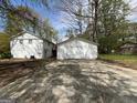Exterior of a detached two car garage with a wide concrete driveway and white siding at 1397 Iron Gate Blvd, Jonesboro, GA 30238